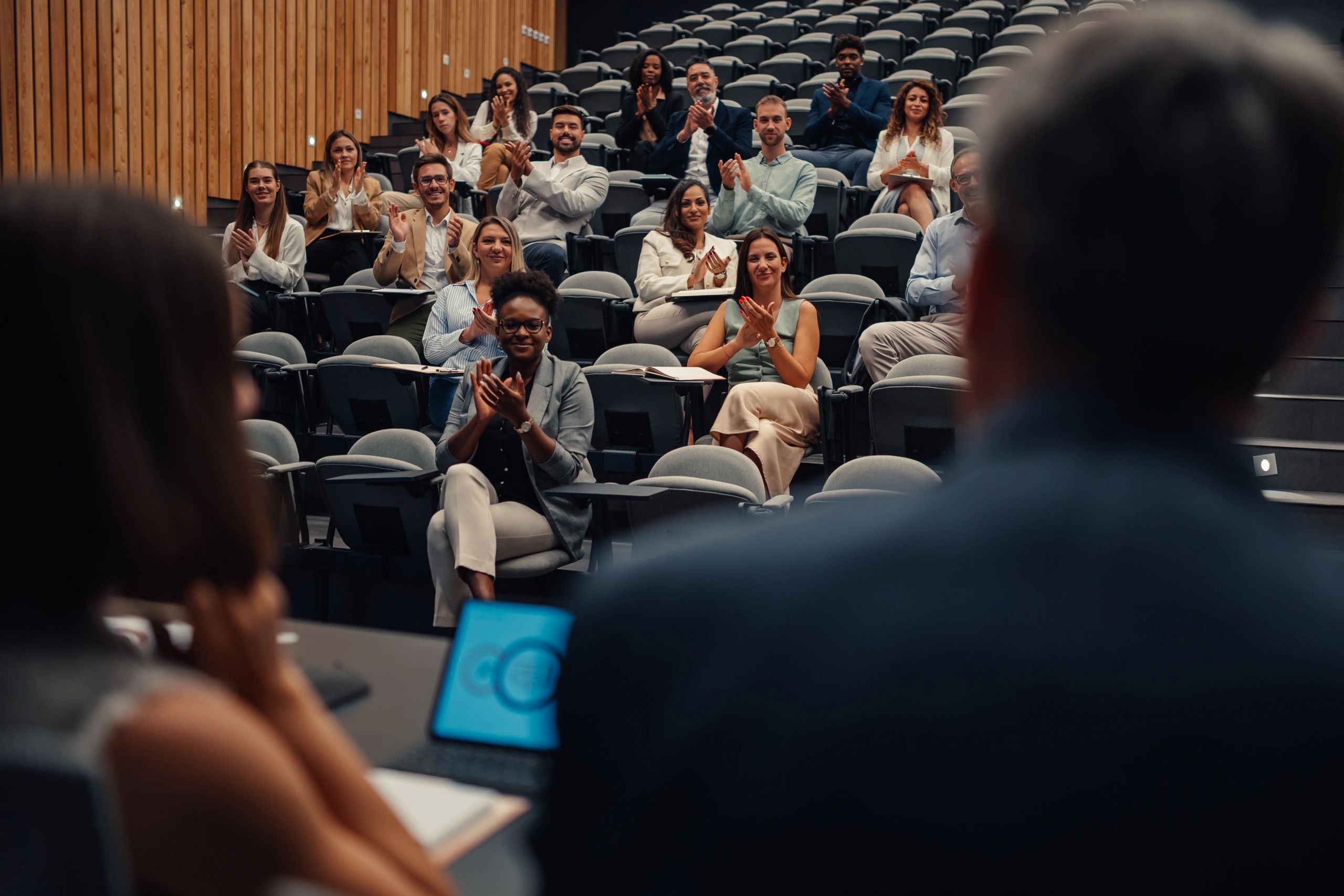 Audience applauding at a professional conference